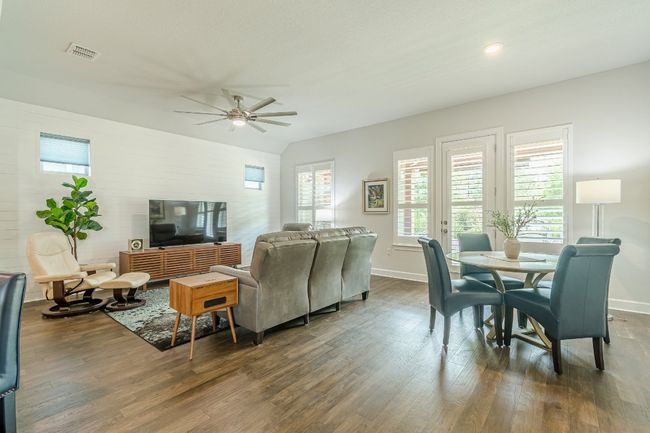 Living room with dark wood-style flooring, ceiling fan, baseboards, and recessed lighting | Image 21