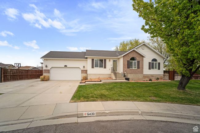 Ranch-style house featuring fence, a front yard, concrete driveway, and an attached garage | Image 34