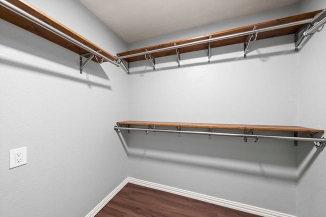 Spacious closet featuring dark wood-style flooring | Image 22