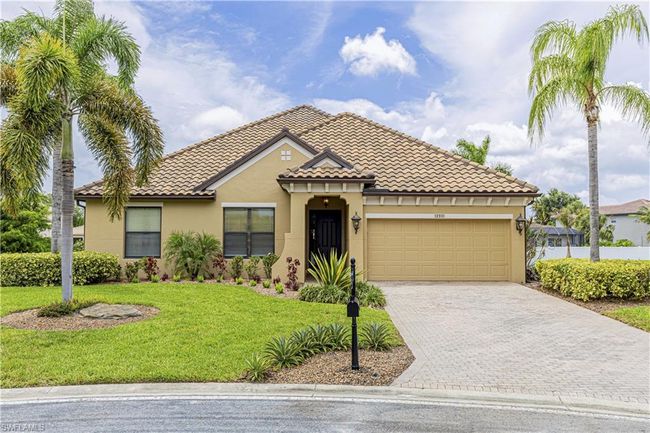 Mediterranean / spanish house featuring a front yard, driveway, an attached garage, stucco siding, and a tiled roof | Image 28