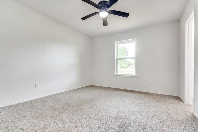 Carpeted spare room with baseboards and a ceiling fan | Image 24