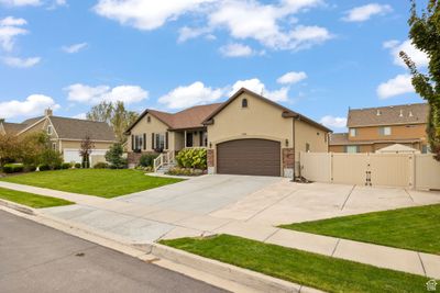 View of front facade with a front yard and a garage. Wide gate allows for RV parking | Image 3