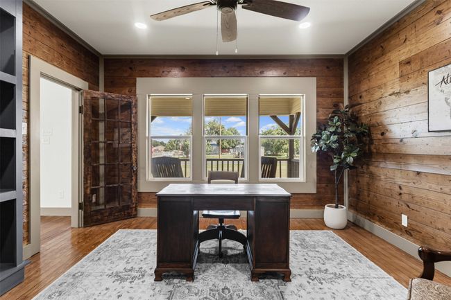 Home office with wooden walls, ceiling fan, baseboards, wood finished floors, and recessed lighting | Image 19