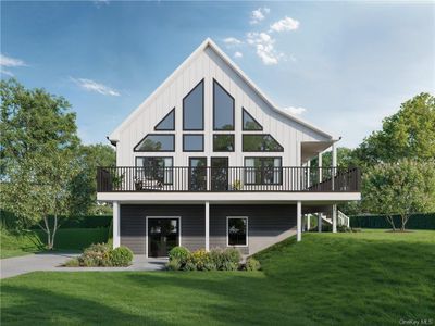 View of front facade featuring a deck and a front lawn | Image 1