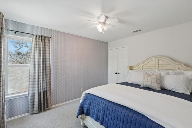 Carpeted bedroom featuring ceiling fan and a closet | Image 26