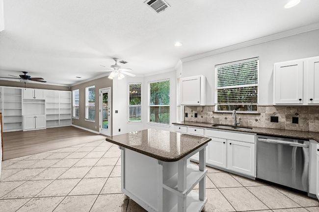Kitchen featuring dishwasher, ceiling fan, ornamental molding, light tile patterned floors, and recessed lighting | Image 4