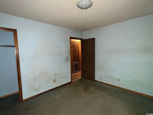Unfurnished bedroom with carpet flooring, baseboards, and a closet | Image 18