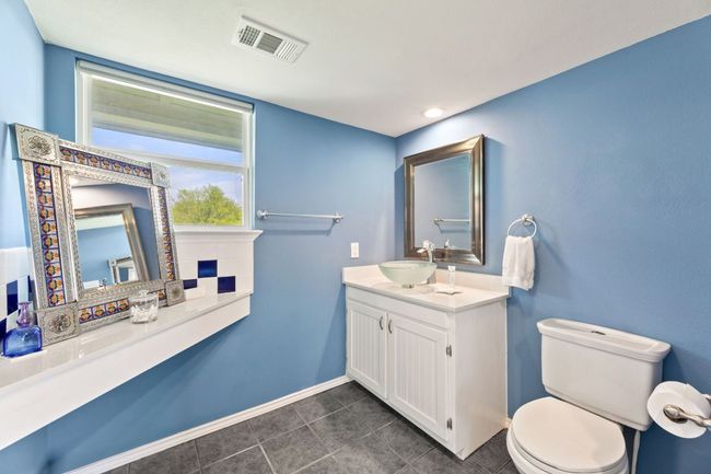 Bathroom featuring visible vents, baseboards, toilet, tile patterned floors, and vanity | Image 17