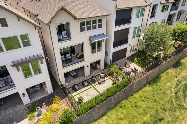 Photo of the back of the home showing extra space provided with stone patio and gas line to outdoor fire pit. | Image 36