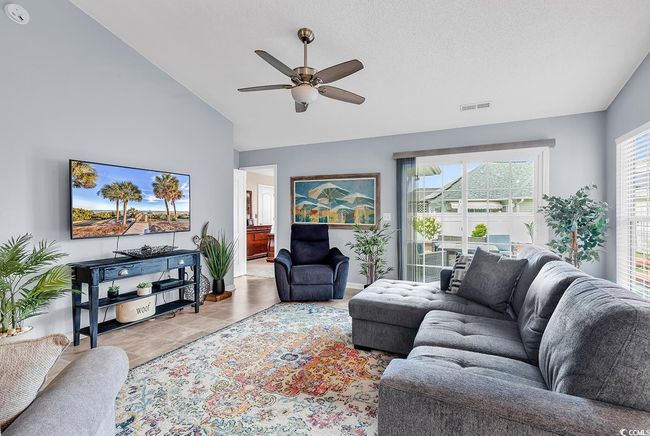 Living room featuring vaulted ceiling and a ceiling fan | Image 31