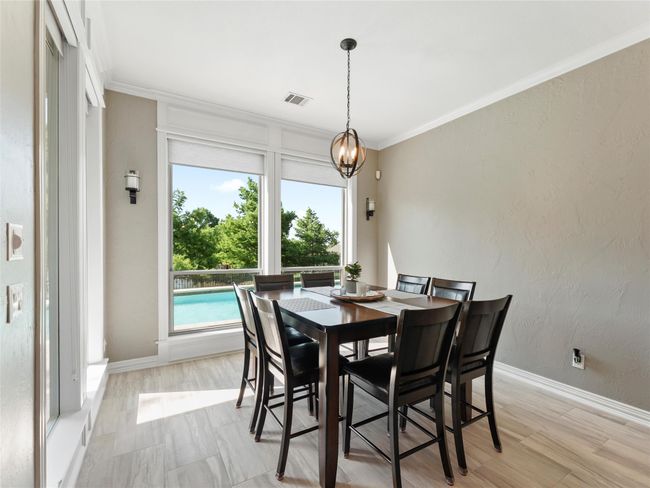 Dining area with crown molding and light wood-style flooring | Image 19
