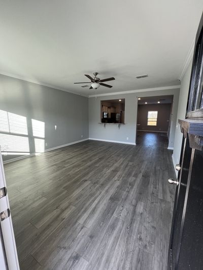 The following photos are NOT the actual home. *STOCK PHOTOS great room with laminate flooring, blinds, craftsman door | Image 3