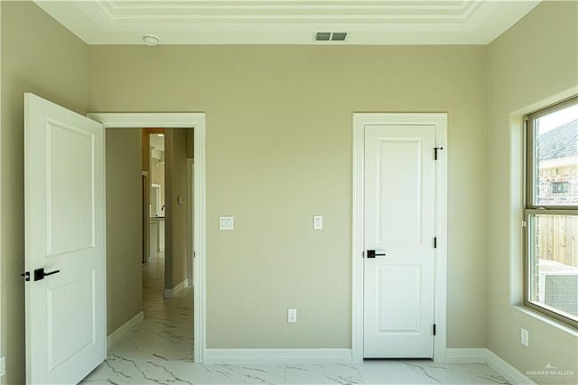 Unfurnished bedroom with marble finish floor, visible vents, and baseboards | Image 25