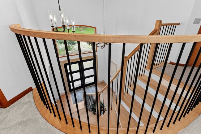Stairs with a chandelier and carpet floors | Image 8