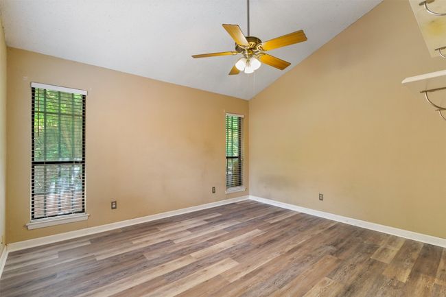Primary bedroom with ceiling fan, vaulted ceiling and new plank floors | Image 8