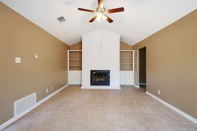 Tile floors and a central fireplace | Image 6