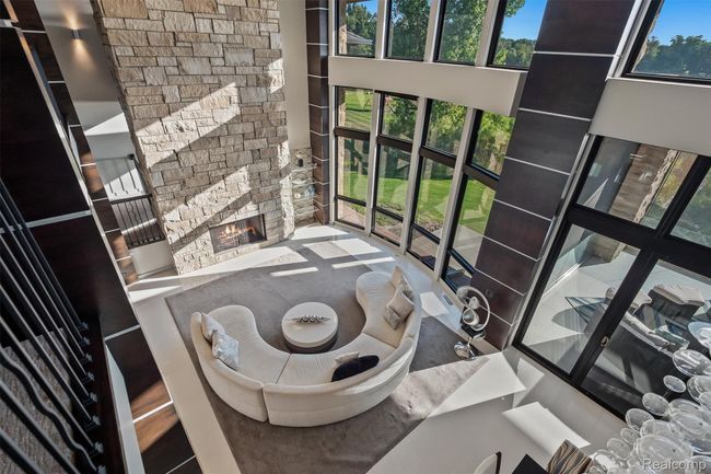 Living room featuring a fireplace and a towering ceiling | Image 43