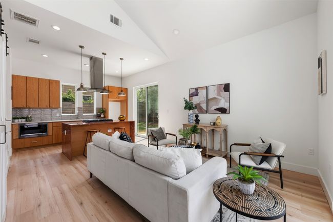 Living area with light wood-type flooring, vaulted ceiling, recessed lighting, and baseboards | Image 4