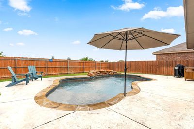 Beautiful Pool with Tanning Ledge and Soothing Waterfall. | Image 3