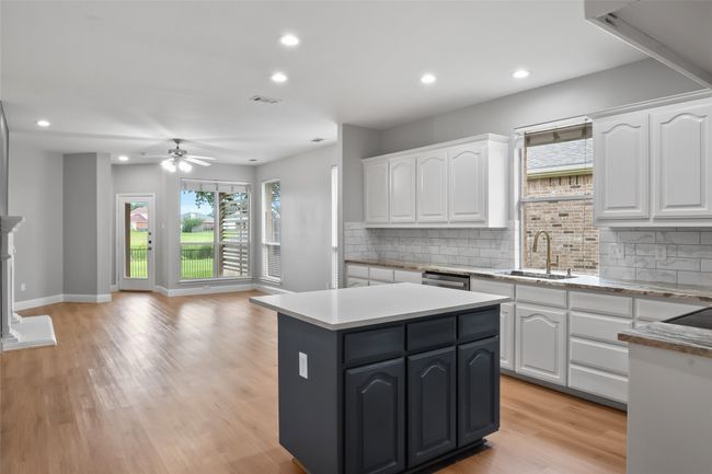 Kitchen featuring a sink, white cabinets, healthy amount of natural light, and recessed lighting | Image 6
