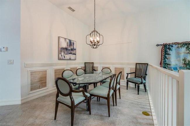 Dining area with a chandelier | Image 9
