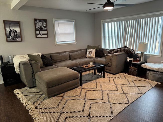 Living room featuring hardwood / wood-style flooring and ceiling fan | Image 8