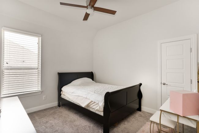 Carpeted bedroom featuring baseboards, a ceiling fan, and vaulted ceiling | Image 31