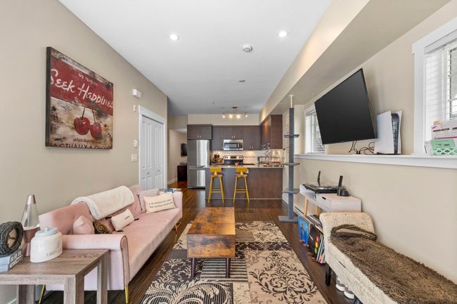 Living area with recessed lighting, dark wood-style flooring, and plenty of natural light | Image 4