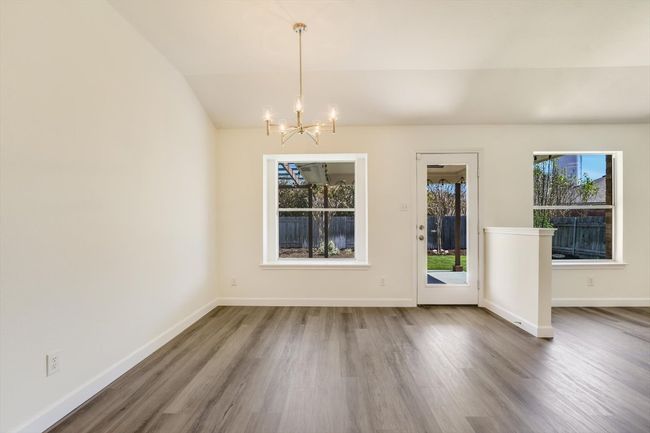 Breakfast room off the kitchen with a window seat and views to the patio and yard. | Image 13