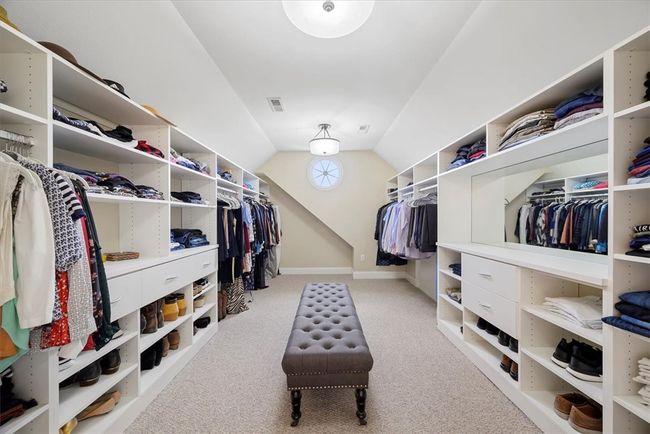 The huge walk-in closet is just beyond the master bath with custom built-in shelving. | Image 28