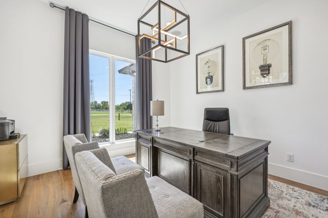 Home office featuring a chandelier and light wood-type flooring | Image 8