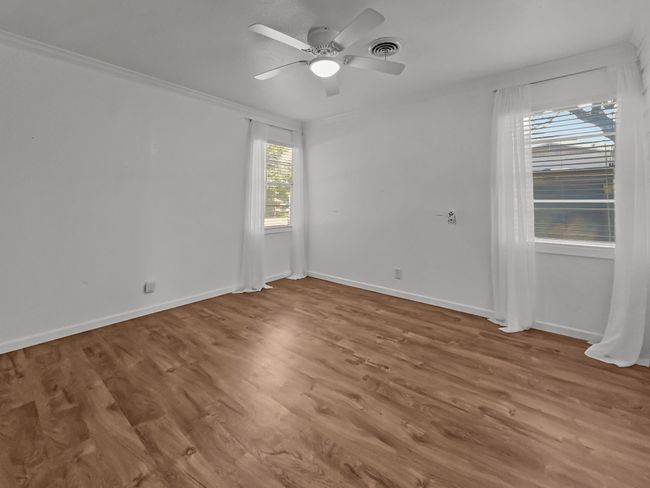 Unfurnished room with ceiling fan and wood finished floors | Image 8