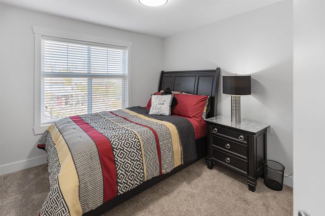 Bedroom with light, carpet and baseboards | Image 13