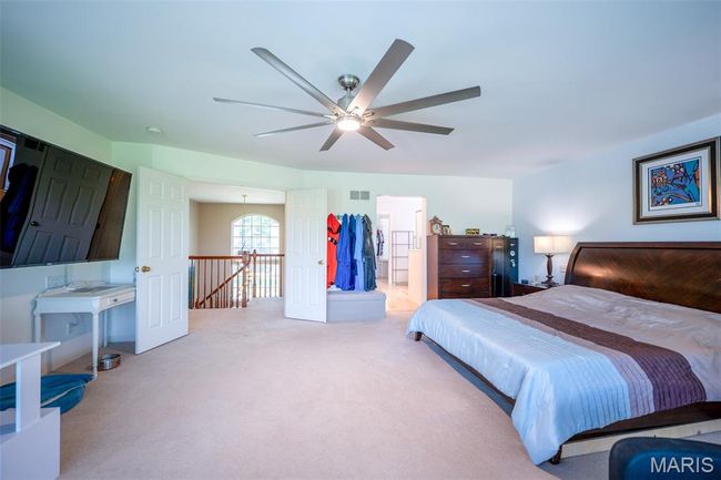 Bedroom featuring carpet, ensuite bathroom, and ceiling fan | Image 25