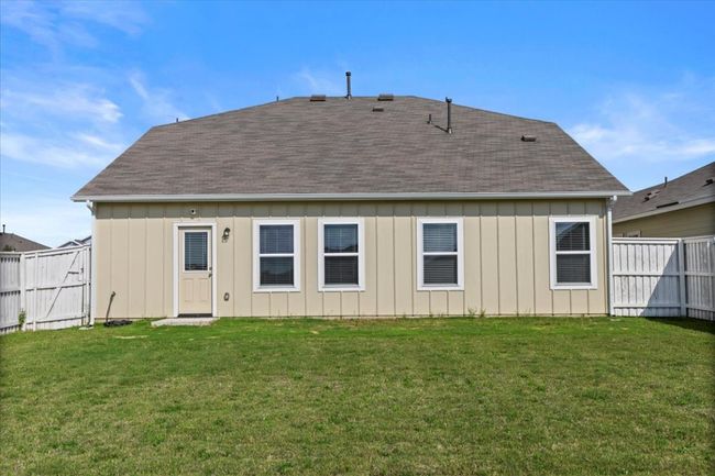 Rear view of house with board and batten siding and a shingled roof | Image 33