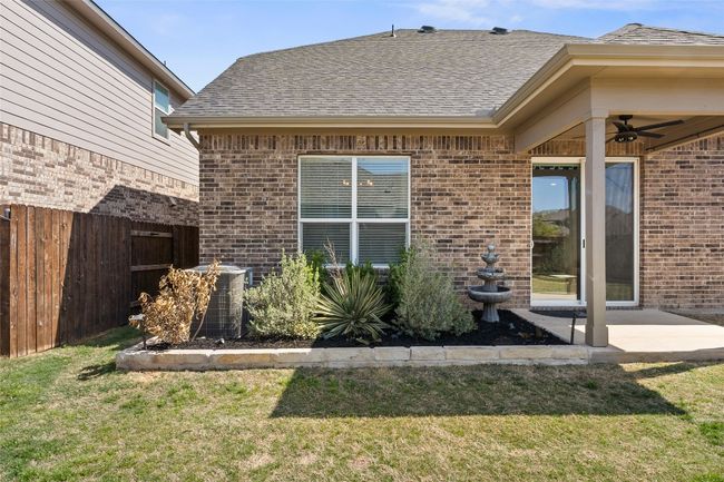 Back of property featuring a yard, fence, brick siding, and roof with shingles | Image 37