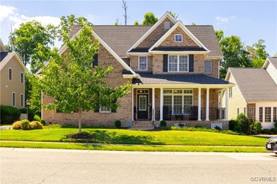 Craftsman inspired home with a porch and a front lawn | Image 1