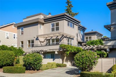 Welcome to this light-filled, end-unit townhome/condominium, offering a spacious two-car garage, lush landscaping, and a private entry in the sought-after Olympic Hills neighborhood. | Image 1