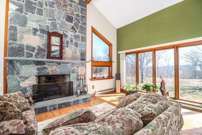 Beautiful stonework in the living room, and another set of windows looking out on a one-of-a-kind view. | Image 18