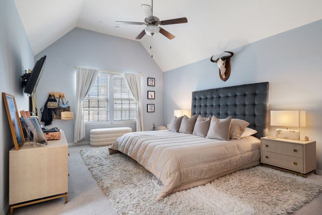 Bedroom with carpet floors, vaulted ceiling, and a ceiling fan | Image 13