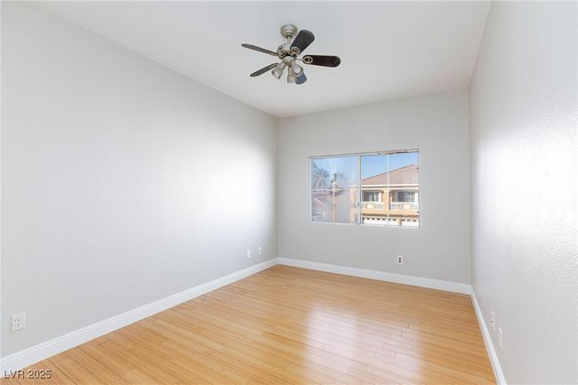 Empty room featuring light wood finished floors, baseboards, and a ceiling fan | Image 38