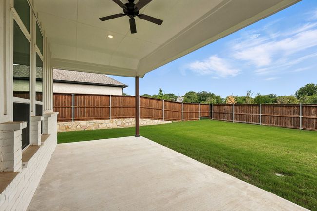 Fenced backyard with a patio and ceiling fan | Image 28