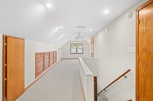 Hallway with vaulted ceiling and light colored carpet | Image 16