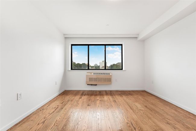 Spare room featuring wood finished floors and a wall mounted AC | Image 27