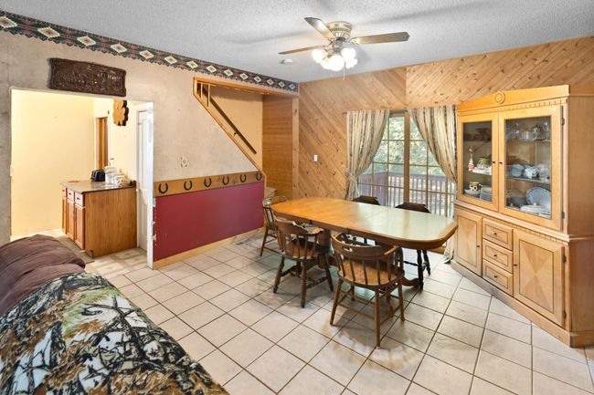 Dining room with sliding patio door opens out to the deck on the west side of the home. | Image 10