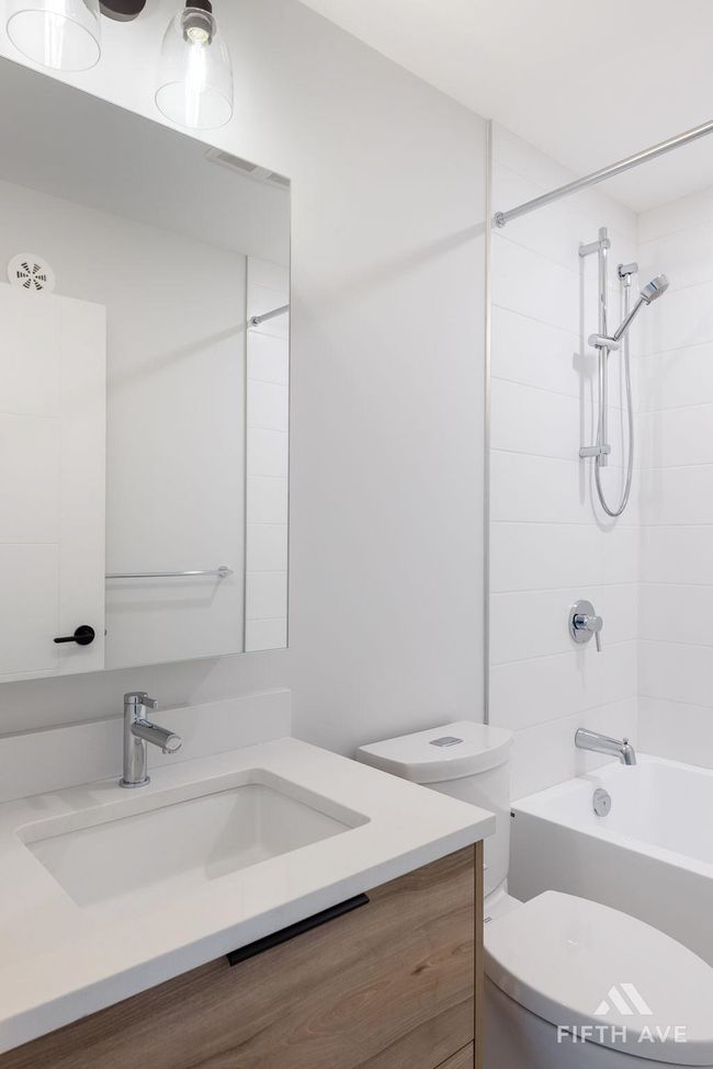 Bathroom featuring vanity and tub / shower combination | Image 28