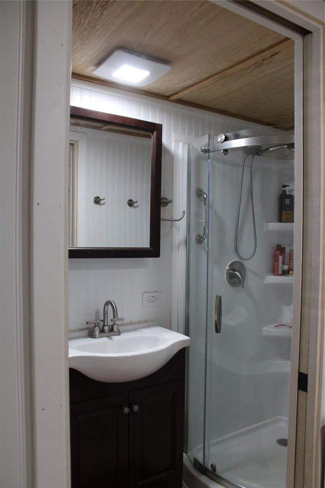 Full bath featuring a stall shower, vanity, and backsplash | Image 8