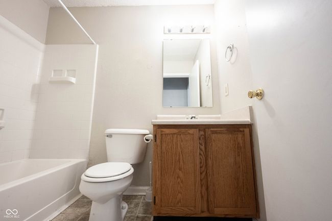full bath featuring vanity, bathtub / shower combination, baseboards, toilet, and tile patterned flooring | Image 26