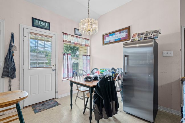 Dining room featuring a chandelier and vaulted ceiling | Image 12