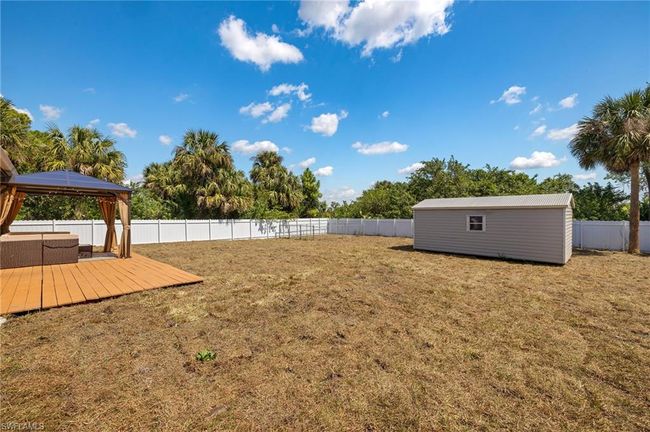 View of yard with a fenced backyard, an outbuilding, and a deck | Image 25